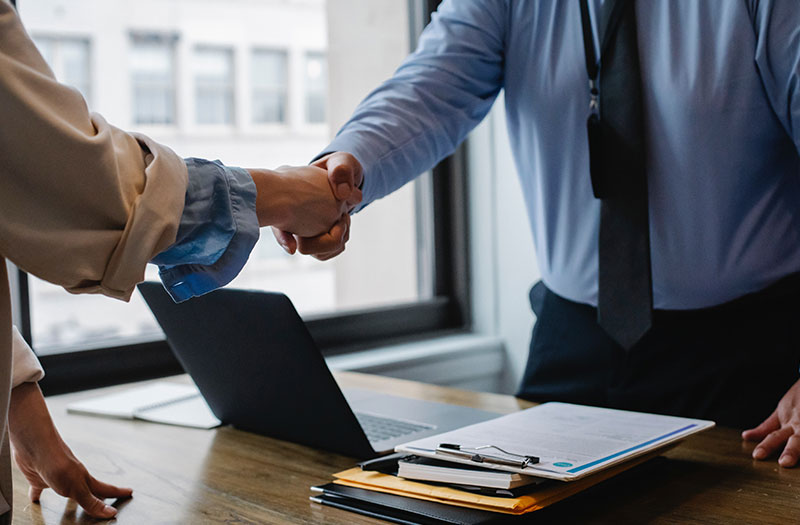 Professionals shaking hands on a brokerage deal