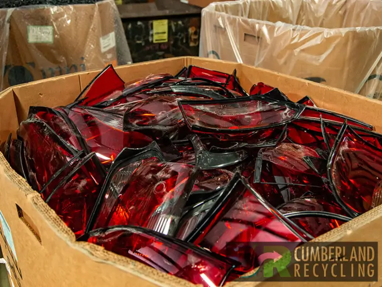 A box of red plastic sunglasses placed on a table in Franklin, Tennessee