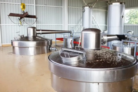 Large metal tank with a man in front, located at Cumberland Recycling in Franklin, TN